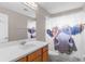 Bathroom featuring a decorative shower curtain, a functional vanity with modern fixtures at 5981 Willows Bridge Loop, Ellenton, FL 34222