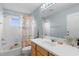 Bright bathroom featuring a tub and shower, blue accent wall, and a unique shower curtain at 5981 Willows Bridge Loop, Ellenton, FL 34222