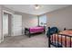 Bedroom featuring two beds, a chair, large window and an entry door at 5981 Willows Bridge Loop, Ellenton, FL 34222