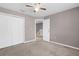 Bedroom with standard closet and carpeted floor leading to an open hallway with a stairway at 5981 Willows Bridge Loop, Ellenton, FL 34222