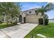 Charming two-story home with a well-manicured lawn and a spacious two-car garage at 5981 Willows Bridge Loop, Ellenton, FL 34222