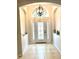 Inviting foyer with tile flooring, elegant light fixture and decorative niche at 5981 Willows Bridge Loop, Ellenton, FL 34222
