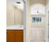 Bathroom vanity leading to a bedroom with a ceiling fan, showcasing an open-concept design at 5981 Willows Bridge Loop, Ellenton, FL 34222
