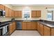 Spacious kitchen with stainless steel appliances, ample counter space, and bright lighting at 5981 Willows Bridge Loop, Ellenton, FL 34222