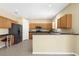 Bright kitchen featuring wooden cabinets, stainless steel appliances, and a cozy breakfast nook at 5981 Willows Bridge Loop, Ellenton, FL 34222