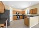 Well-lit kitchen featuring stainless steel appliances, wooden cabinets, and tile flooring at 5981 Willows Bridge Loop, Ellenton, FL 34222