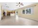 Spacious living room featuring tile floors, ceiling fan, and sliding glass doors to the outside at 5981 Willows Bridge Loop, Ellenton, FL 34222