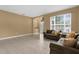 Living area with large windows, neutral walls, and comfortable sofas at 5981 Willows Bridge Loop, Ellenton, FL 34222