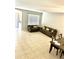Spacious living room featuring tile flooring and comfortable seating, connecting to dining area at 5981 Willows Bridge Loop, Ellenton, FL 34222