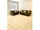 Cozy living room with tile flooring and comfortable seating, ideal for relaxation at 5981 Willows Bridge Loop, Ellenton, FL 34222