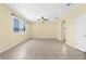 A living room features neutral tile flooring, a ceiling fan and a sunny window at 5981 Willows Bridge Loop, Ellenton, FL 34222