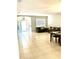 Open-concept living room with tile flooring, seamlessly connecting living and dining areas at 5981 Willows Bridge Loop, Ellenton, FL 34222