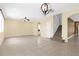 Bright living room featuring neutral paint, tile flooring, staircase, and modern lighting at 5981 Willows Bridge Loop, Ellenton, FL 34222