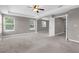 Spacious main bedroom featuring neutral paint, plush carpet, and arched entry at 5981 Willows Bridge Loop, Ellenton, FL 34222