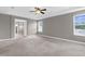 Large main bedroom with plush carpet, tray ceilings, and ensuite bathroom at 5981 Willows Bridge Loop, Ellenton, FL 34222