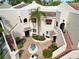 Overhead view of a charming condo complex with a central fountain, terracotta roofs, and brick pavers at 6101 34Th W St # 11C, Bradenton, FL 34210