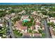 Expansive aerial view featuring tile roofed townhomes with landscaped greenery, a community pool, and surrounding suburban scenery at 6101 34Th W St # 11C, Bradenton, FL 34210