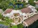 Overhead view of the residential complex near a pond, featuring brick pavers and terracotta roofs at 6101 34Th W St # 11C, Bradenton, FL 34210