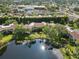 Stunning aerial view showcasing a peaceful lake surrounded by lush greenery and beautiful homes at 6101 34Th W St # 11C, Bradenton, FL 34210