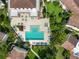 Aerial view of a community pool featuring crystal clear water, surrounded by lush landscaping, lounge chairs, and manicured lawns at 6101 34Th W St # 11C, Bradenton, FL 34210