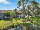 Scenic view of condos bordered by a pond and featuring well-maintained landscaping and mature trees at 6101 34Th W St # 11C, Bradenton, FL 34210