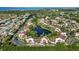 Expansive aerial view of a lake front community featuring a central lake, lush landscaping, and suburban scenery at 6101 34Th W St # 11C, Bradenton, FL 34210
