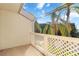 Private balcony with a white lattice railing and view of palm trees and blue sky at 6101 34Th W St # 11C, Bradenton, FL 34210