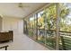 Expansive screened balcony overlooking a tranquil lake and mature trees at 6101 34Th W St # 11C, Bradenton, FL 34210