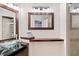 Bathroom featuring a vanity with a glass sink, a shelf, and a mirror at 6101 34Th W St # 11C, Bradenton, FL 34210