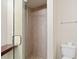 Bright bathroom featuring a walk-in shower with tiled walls and floors, and a modern toilet at 6101 34Th W St # 11C, Bradenton, FL 34210