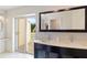 Bathroom featuring a double sink vanity with sliding glass doors to the balcony at 6101 34Th W St # 11C, Bradenton, FL 34210