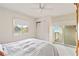 A bedroom with white walls, a full bed, a window, and a sliding glass door to a balcony at 6101 34Th W St # 11C, Bradenton, FL 34210