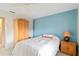 A bedroom with blue colored walls, a full bed, and a wooden armoire at 6101 34Th W St # 11C, Bradenton, FL 34210