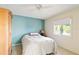 A bedroom with a full bed, turquoise walls, and a wooden armoire at 6101 34Th W St # 11C, Bradenton, FL 34210