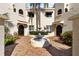 Charming courtyard view with fountain and brick pavers at tan-colored condo at 6101 34Th W St # 11C, Bradenton, FL 34210