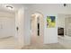 Bright hallway with neutral colors and arched doorway leading to other rooms in the home at 6101 34Th W St # 11C, Bradenton, FL 34210