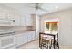 Open kitchen concept flows into breakfast nook with white cabinets and stainless appliances at 6101 34Th W St # 11C, Bradenton, FL 34210