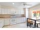 Bright kitchen with white appliances, neutral countertops, and breakfast table at 6101 34Th W St # 11C, Bradenton, FL 34210