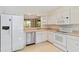 Bright kitchen features white cabinetry, stainless steel appliances and a pass through window to dining area at 6101 34Th W St # 11C, Bradenton, FL 34210