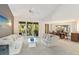 Living room featuring access to a screened-in balcony and an open dining space at 6101 34Th W St # 11C, Bradenton, FL 34210