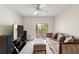 Comfortable living room featuring a ceiling fan and sliding glass doors to the outdoor terrace at 6101 34Th W St # 11C, Bradenton, FL 34210