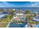 Aerial view of the home with a pool, dock, and outdoor space on a waterfront property at 634 Key Royale Dr, Holmes Beach, FL 34217