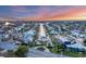 Panoramic aerial sunset view of a waterfront neighborhood with canals and homes along the water at 634 Key Royale Dr, Holmes Beach, FL 34217