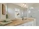 Well-lit bathroom featuring vanity with granite countertop, white cabinets, and a glass enclosed walk in shower at 634 Key Royale Dr, Holmes Beach, FL 34217