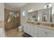 Bright bathroom with double vanity, shower, and soaking tub at 634 Key Royale Dr, Holmes Beach, FL 34217