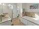 Bright bathroom with double vanity, shower, and soaking tub at 634 Key Royale Dr, Holmes Beach, FL 34217