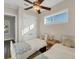 Comfortable bedroom with twin beds, ample sunlight, and a ceiling fan at 634 Key Royale Dr, Holmes Beach, FL 34217