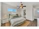 Bright bedroom featuring a ceiling fan, wood floors, a cozy rug, and ensuite bathroom for added convenience at 634 Key Royale Dr, Holmes Beach, FL 34217