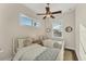 Charming bedroom with two twin beds, lots of natural light, and tasteful decorations at 634 Key Royale Dr, Holmes Beach, FL 34217