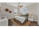 Well-lit bedroom with a comfortable bed, a ceiling fan, and decorative wall art at 634 Key Royale Dr, Holmes Beach, FL 34217